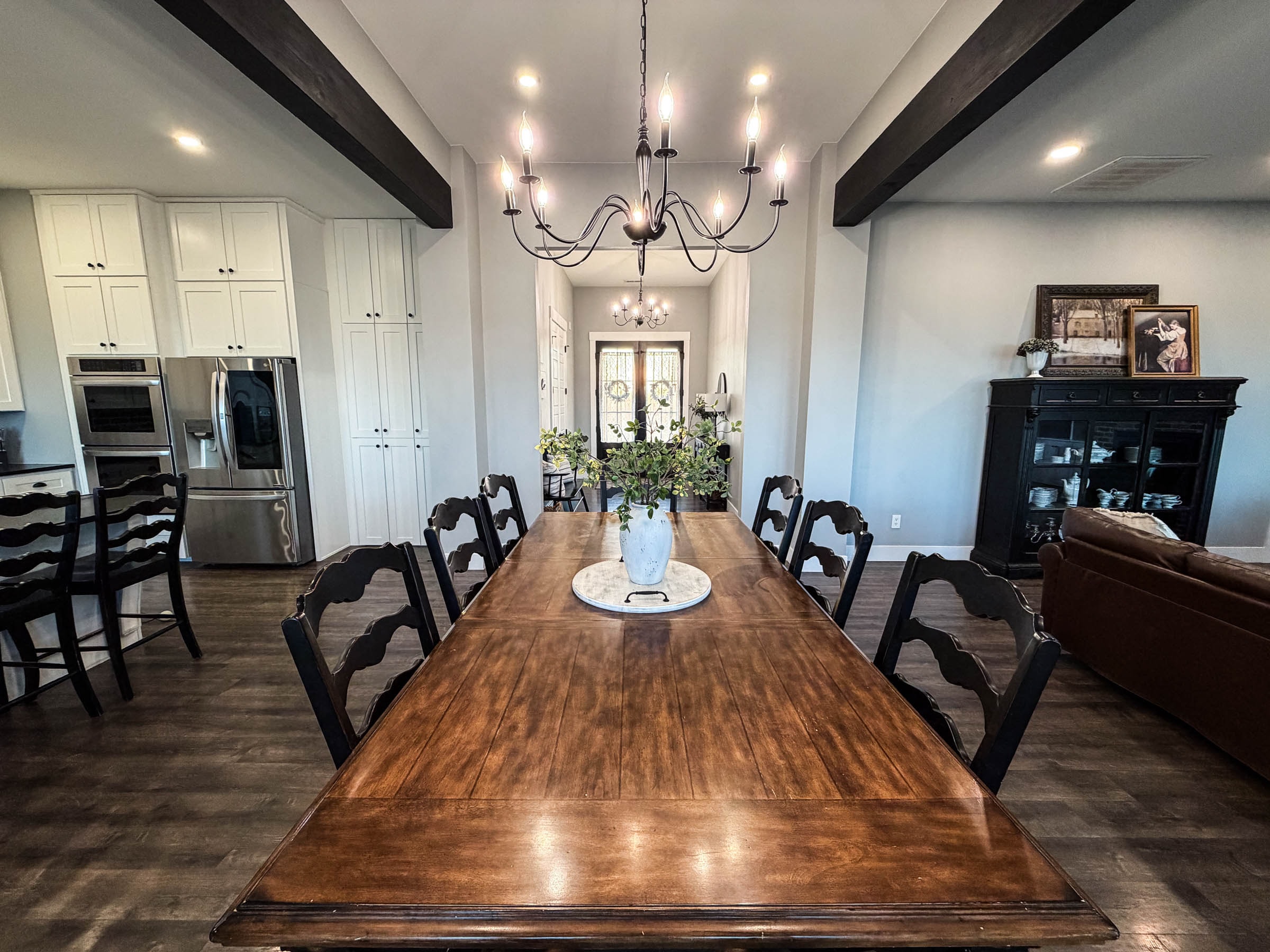 Dining room with wood beam ceiling and large chandelier