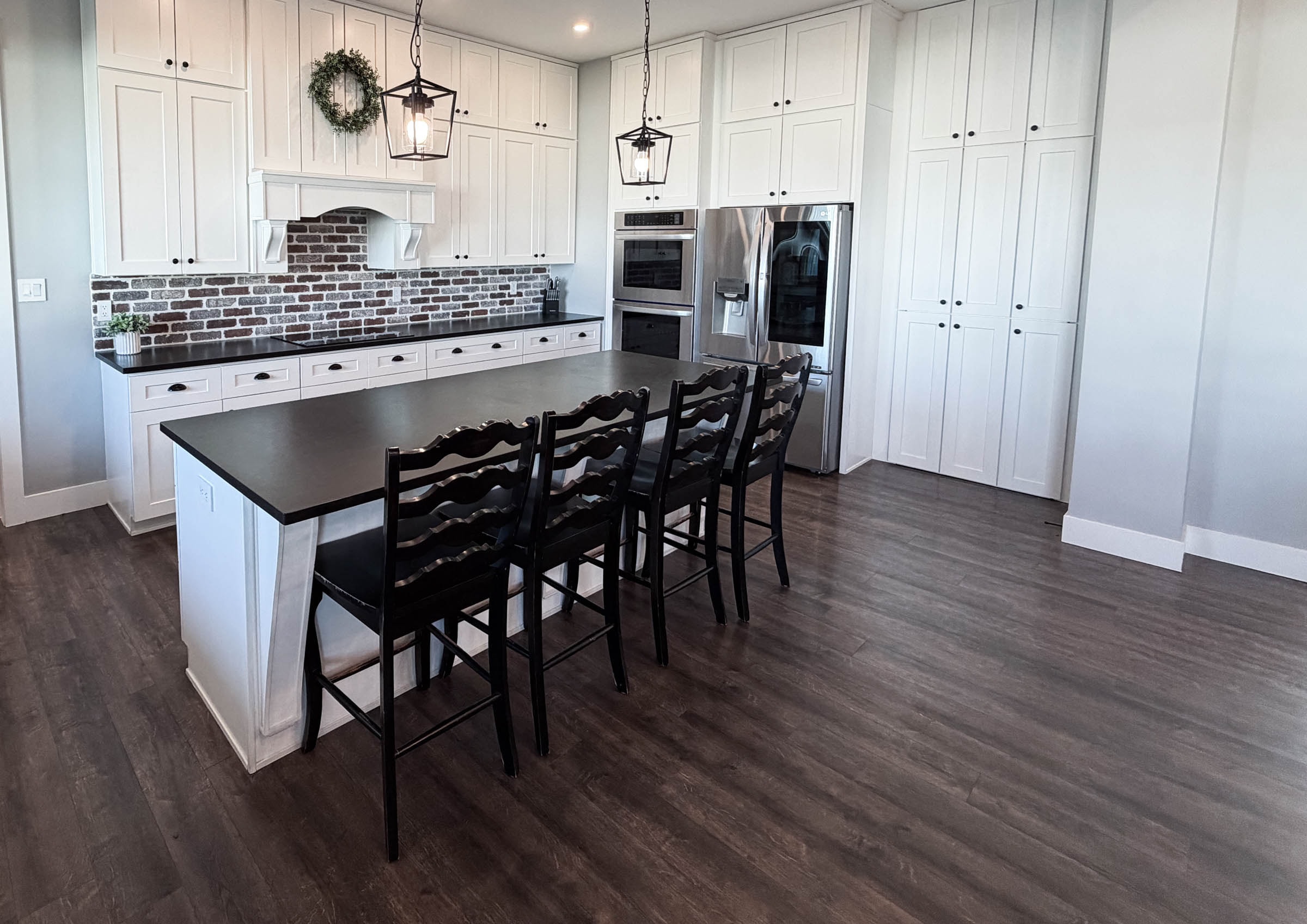 Kitchen island with bar seating and brick backsplash