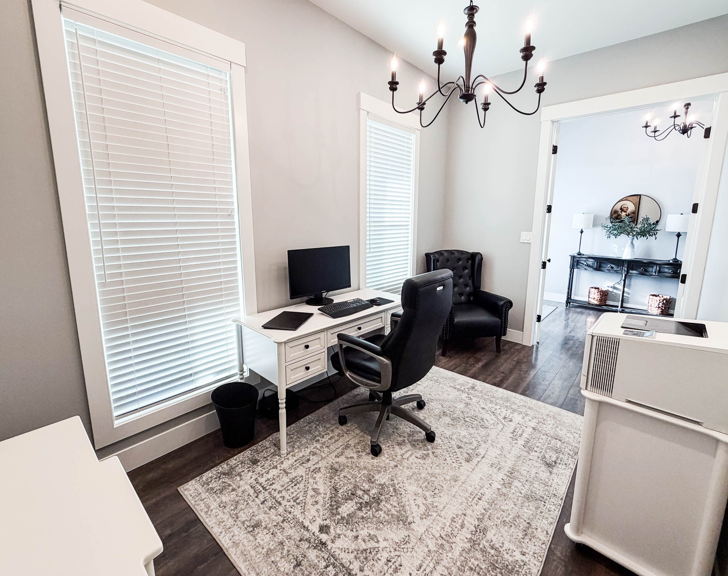 Dedicated office with chandelier and hardwood floors