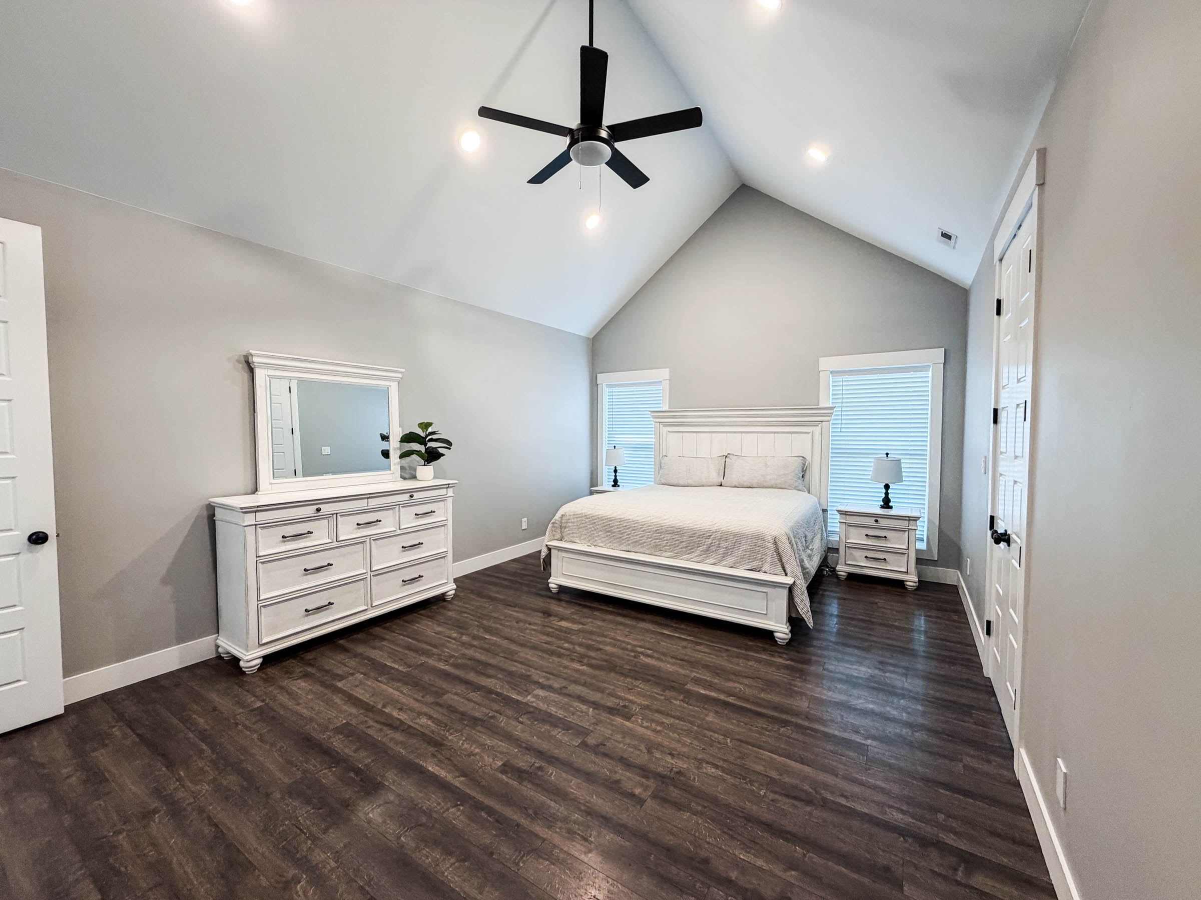 Primary bedroom with vaulted ceiling
