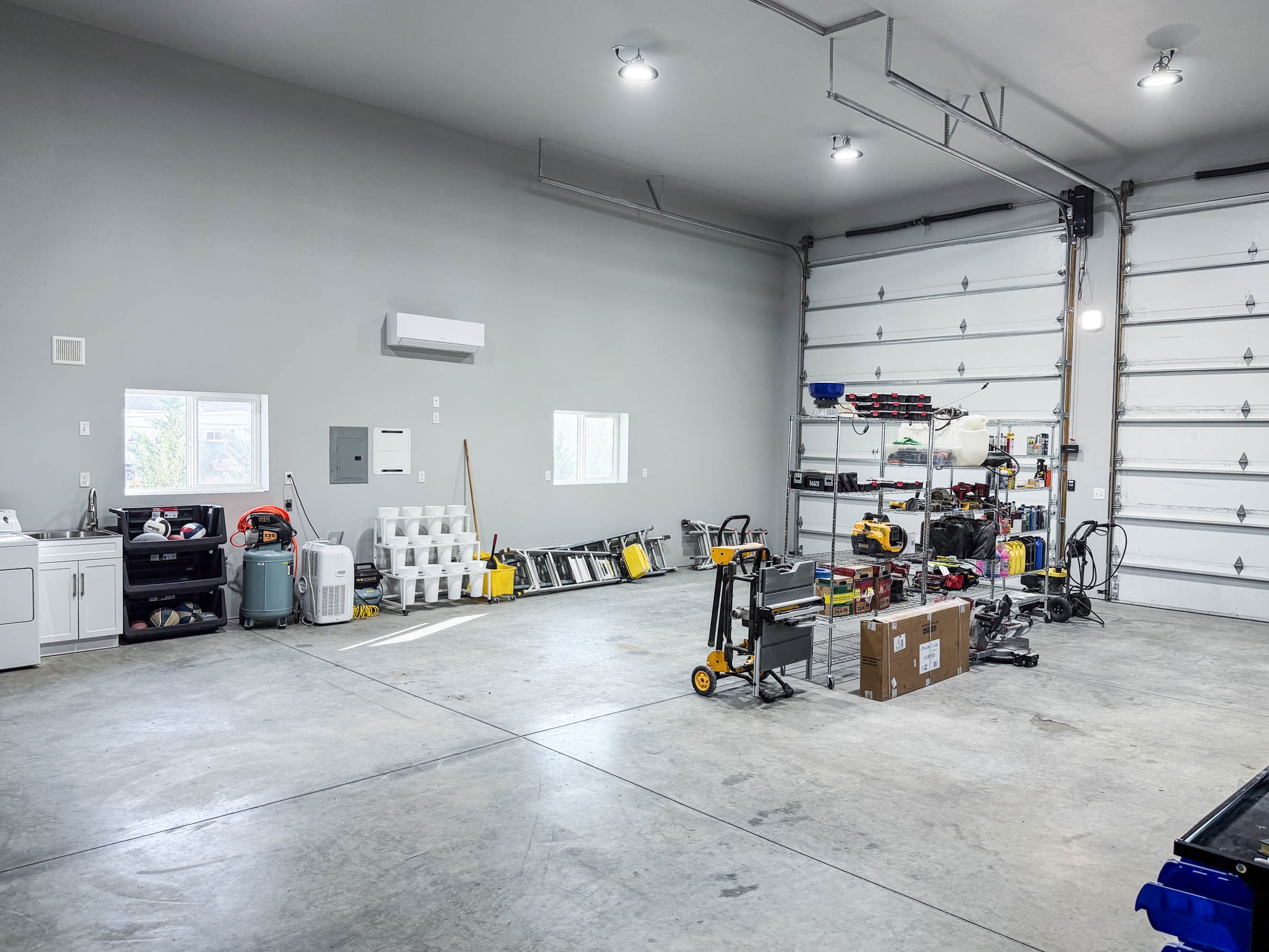 RV shop interior showing utility sink, washer dryer hookups, and open floor space